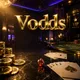 Vodds online casino hero banner with gold chips, playing cards, and dice on dark marble under cinematic lighting