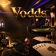 Vodds online casino hero banner with gold chips, playing cards, and dice on dark marble under cinematic casino lighting